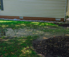 water collecting in yard next to house