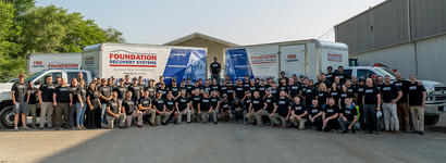 FRS employees standing in front box trucks