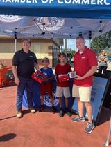 FRS staff pose with two kids at rubber duck race
