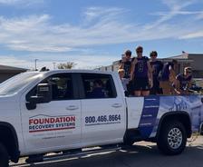 Pacific High School football players standing in a Foundation Recovery Systems truck during the school's 2025 Homecoming parade
