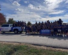 Pacific High School football players standing in a Foundation Recovery Systems truck and float during the school's 2025 Homecoming parade