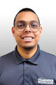 Man wearing glasses and a Foundation Recovery Systems polo shirt, smiling in front of a grey background.