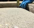 person measuring sunken concrete