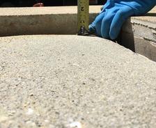 person measuring sunken concrete