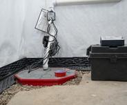 sump pump with a battery backup installed in a basement