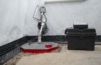 sump pump with a battery backup installed in a basement
