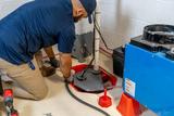 technician servicing a sump pump system