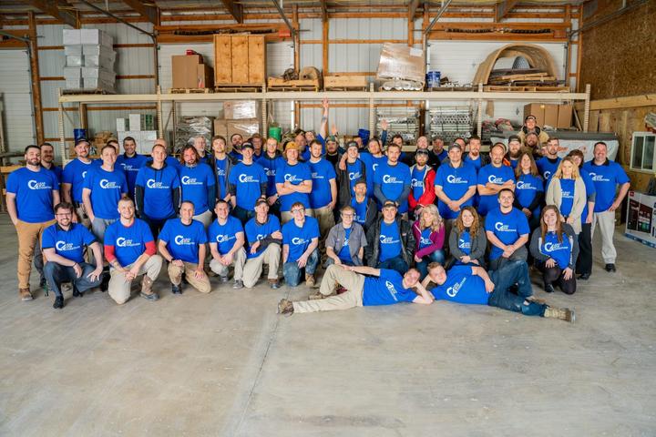 IFS Tribe smiling inside of the warehouse.