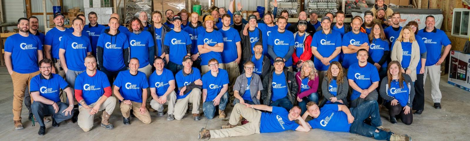 IFS Tribe smiling inside of the warehouse.