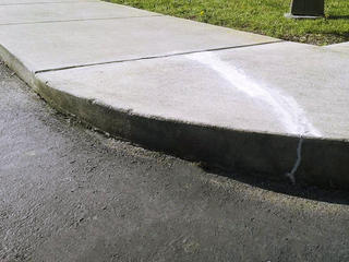 Cracked concrete sidewalk after