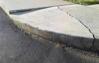 Cracked concrete sidewalk before