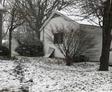 snow covering yards next to house foundations