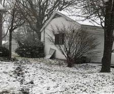 snow covering yards next to house foundations