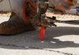 Close-up of hands and worker boot injecting poly.