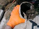 A close-up of a clogged exterior pipe.