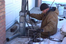 CFI is installing push pier in front of the driveway in the snow.