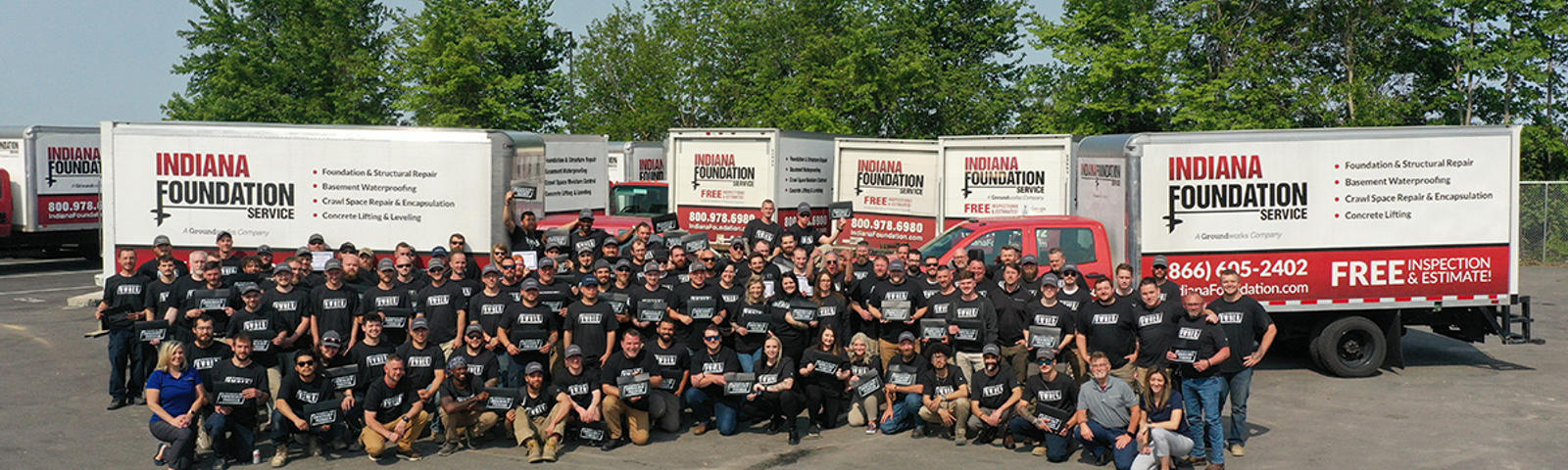 IFS staff outside at the Ownership Tour with supply trucks in the background.