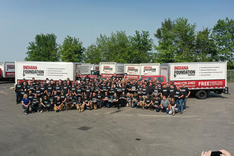 IFS staff outside at the Ownership Tour with supply trucks in the background.