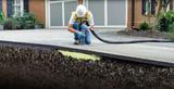 man installing polyurethane foam under concrete driveway