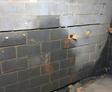 cracking and bowing basement wall with water damage