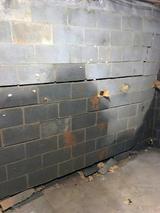 cracking and bowing basement wall with water damage