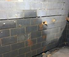 cracking and bowing basement wall with water damage