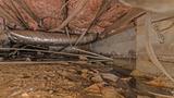 failing fiberglass insulation in a damp crawl space