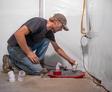 crew member installing a basement sump pump