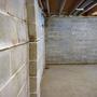cracking and bowing basement wall with efflorescence