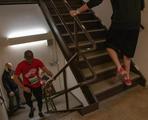 People running up a stairwell during a race event in a building.