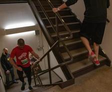 People running up a stairwell during a race event in a building.