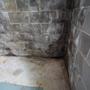 Water stains on the interior basement wall and floor.