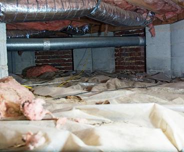 Torn vapor barrier and falling insulation