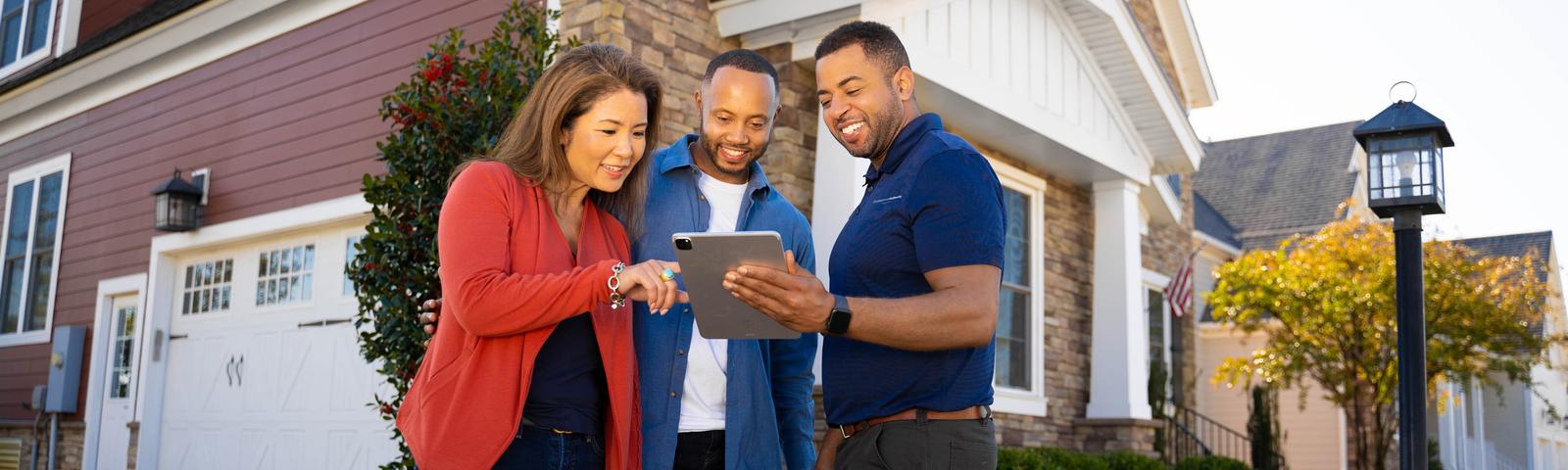 Ohio Basement Authority CFI with couple in front of brick home - desktop hero