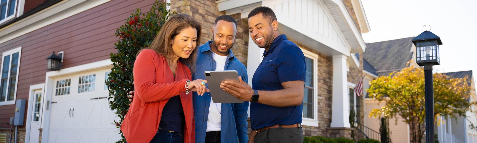 Ohio Basement Authority CFI with couple in front of brick home - desktop hero