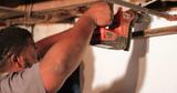 A crew member working on a basement finishing project