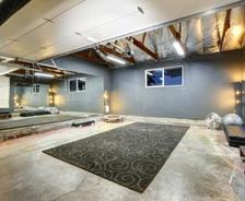large basement gym with mirror wall