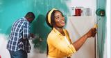 couple painting basement wall