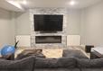 finished basement entertainment center with TV and seating