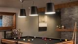 basement entertainment lounge with pool table and pendant lighs