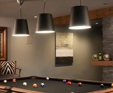 basement entertainment lounge with pool table and pendant lighs