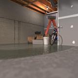 A basement flooding incident has left a bicycle, boxes, and a ladder submerged against the wall.