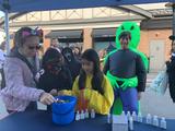 trick-or-treaters visiting the Ohio Basement Authority booth at the Tricks and Treats at Crocker Park event