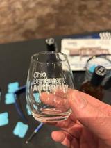 Ohio Basement Authority logo on a souvenir tasting glass from the Cleveland Cheese, Wine, and Chocolate Fest