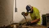 Ohio Basement Authority crew member digging a basement sump pump hole