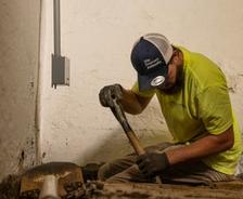 Ohio Basement Authority crew member digging a basement sump pump hole