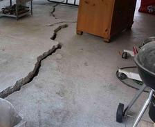 heaving foundation slab with a large crack and gap