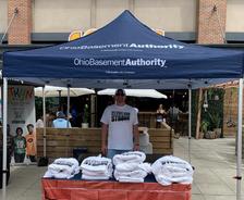 Ohio Basement Authority employee in a company tent at the 2025 ESPN Cleveland Block Party