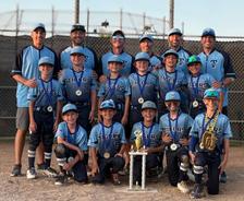 smiling Twinsburg Tigers 10U baseball players and coaches with a 2025 championship trophy
