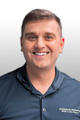Smiling man in a navy polo shirt with "Ohio Basement Authority" logo, standing against a light background.